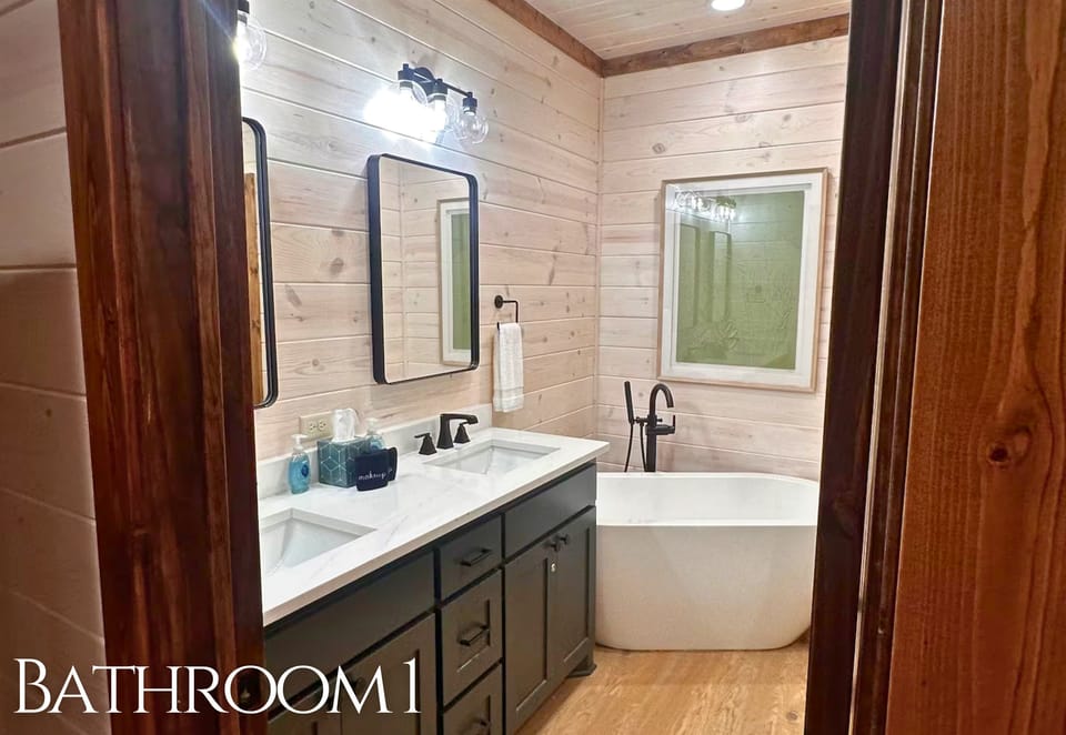 This spa-inspired bathroom invites you to unwind with a freestanding soaking tub, double vanity, and modern rustic charm.