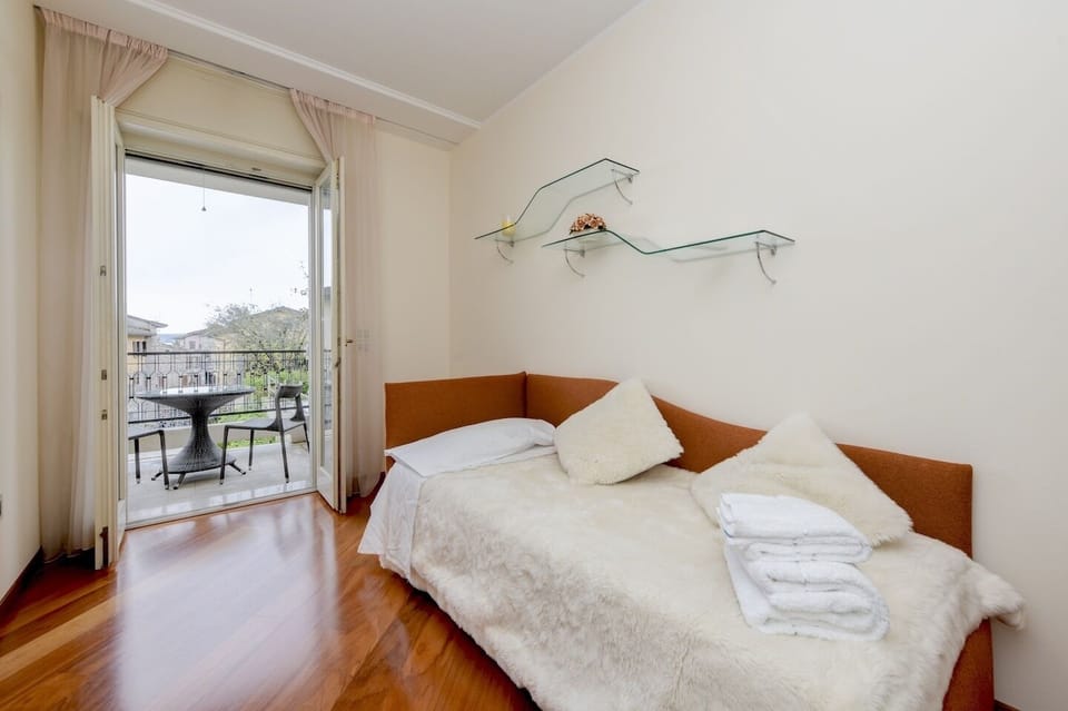 Second bedroom with one queen size bed prepared and entrance to balcony with cit