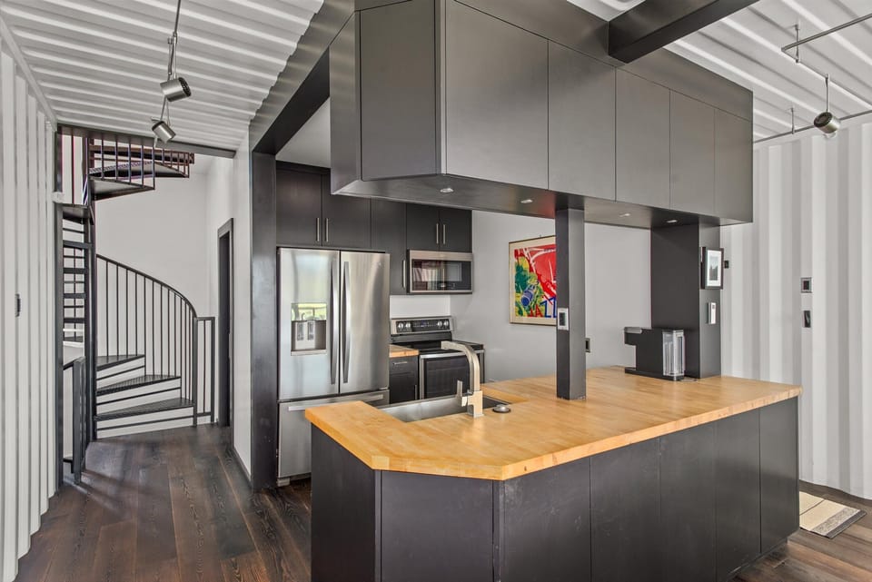 The kitchen is fully equipped with modern appliances