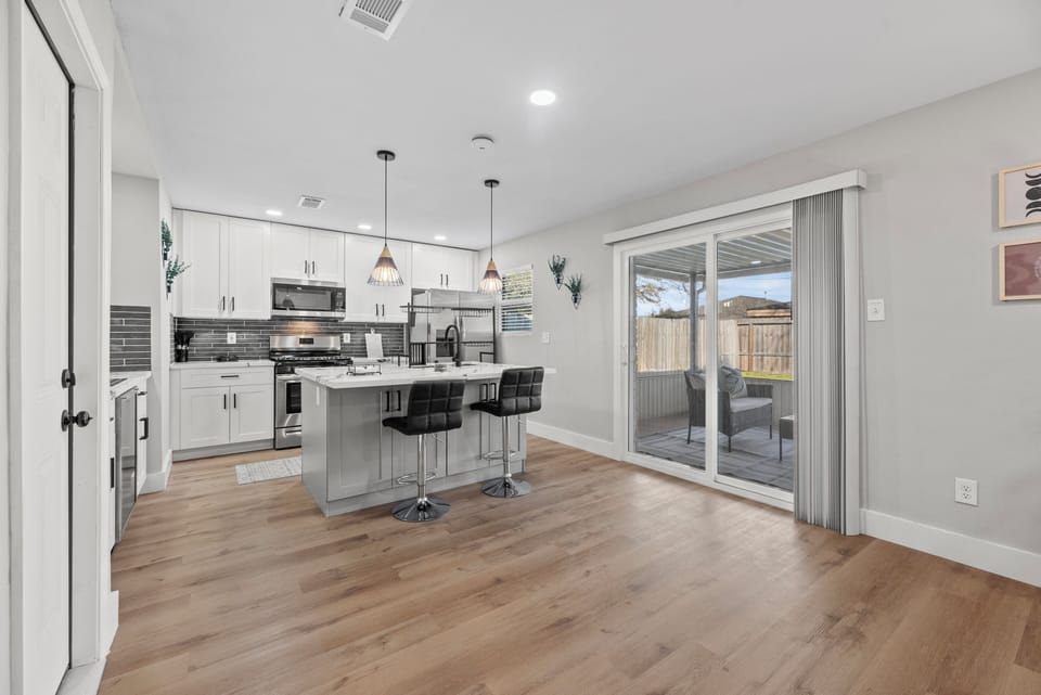Open space linking the kitchen to the patio offering amazing natural light