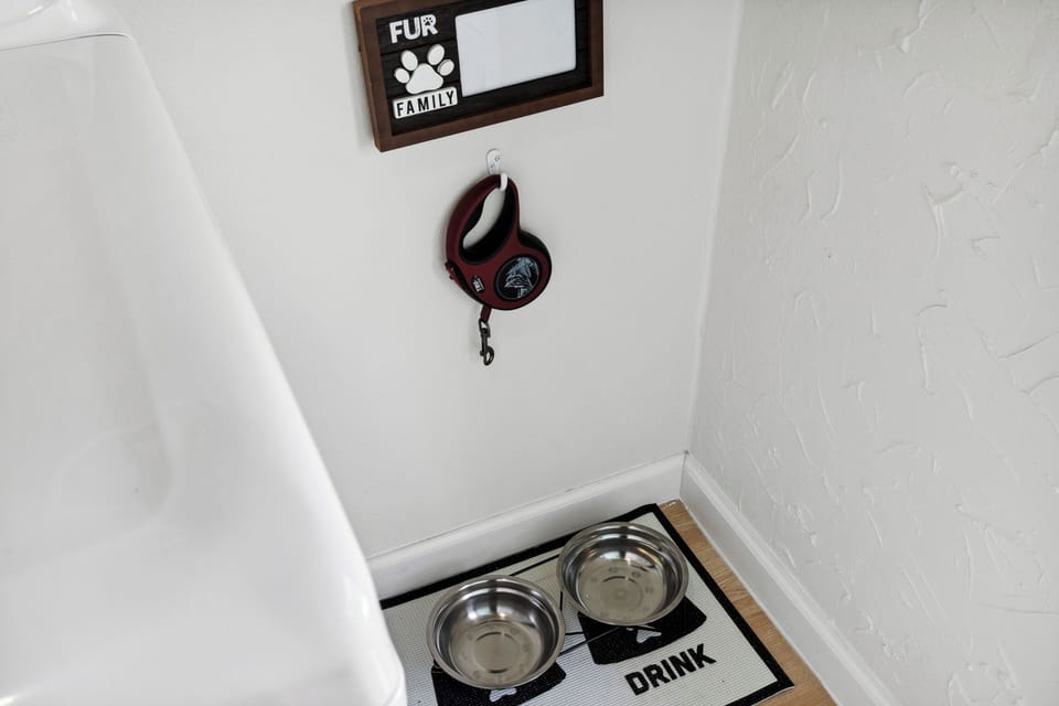 Traveling with a furry friend? This pet-friendly home includes a designated area with food and water bowls and a leash hook, ensuring your pet has everything they need during your stay.