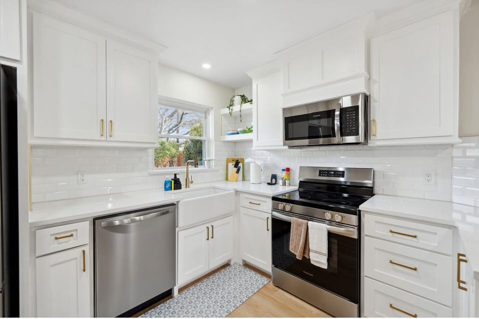 Prepare meals in this beautiful, fully-equipped kitchen with modern appliances and a stylish farmhouse sink.