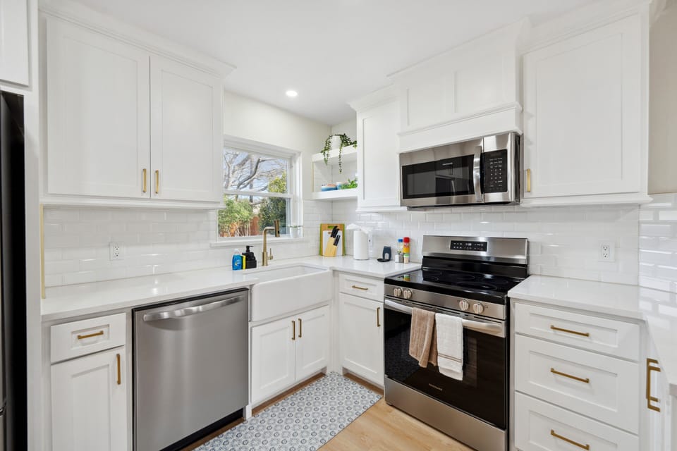 Prepare meals in this beautiful, fully-equipped kitchen with modern appliances and a stylish farmhouse sink.