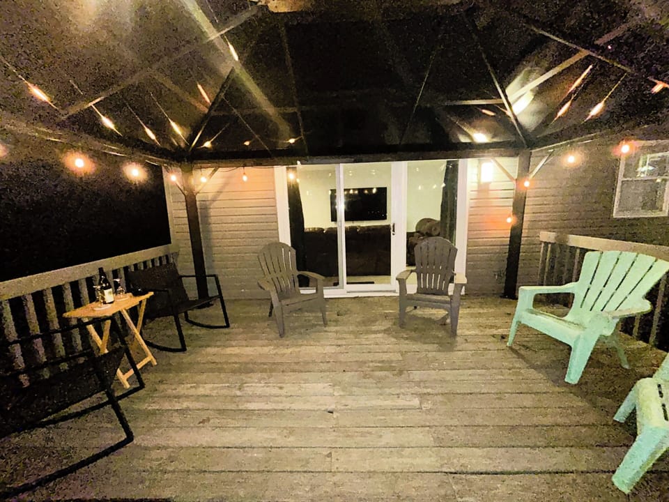 Inviting portico with comfortable chairs, perfect for enjoying good weather.