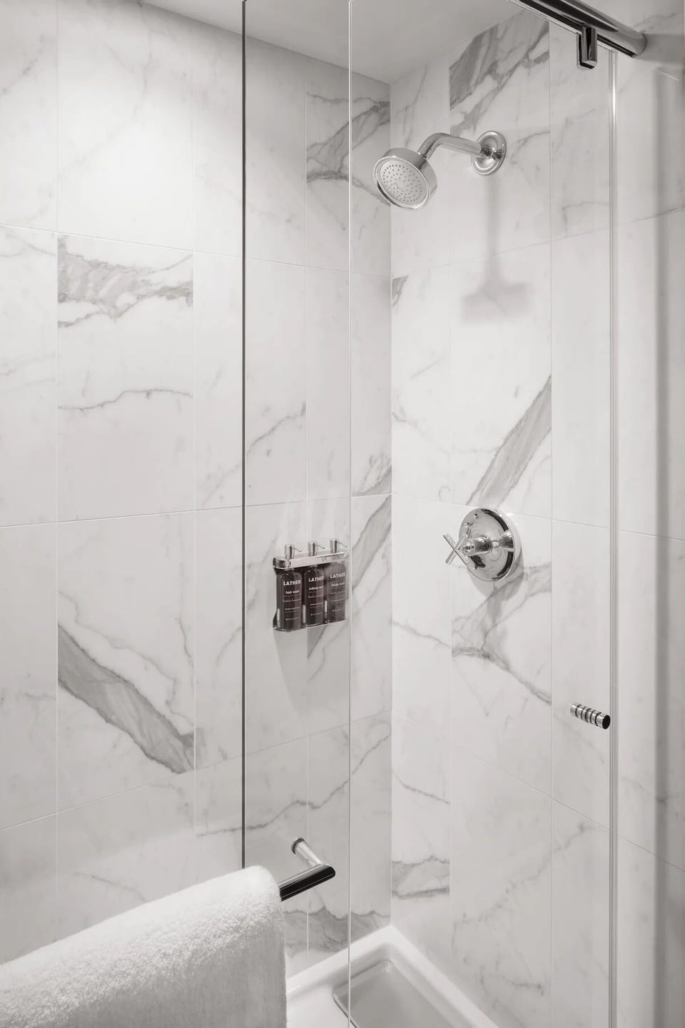Refresh in a bright marble shower with rainfall-style spray.