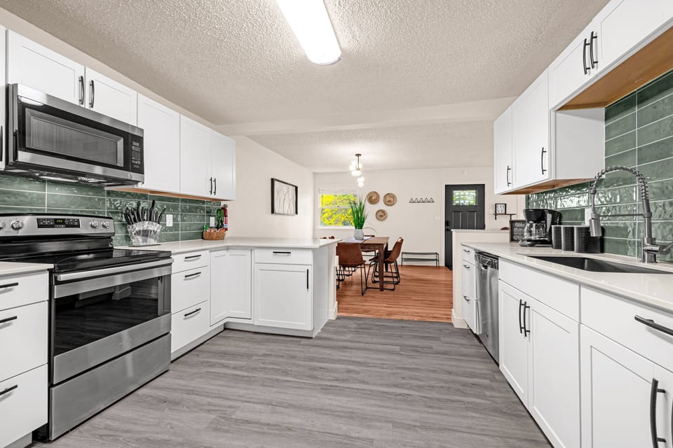 The kitchen is fully stocked with a blender, coffee maker, french press maker, coffee grinder, pots, pans, and cooking utensils to make your meal-prep as easy as pie!