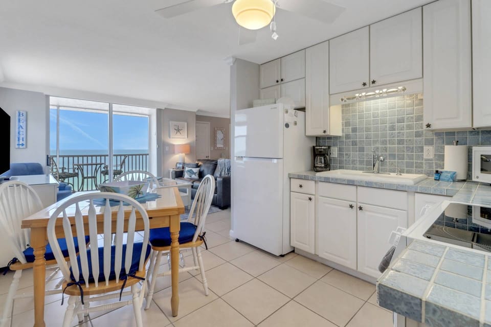 A dining table with seating for 4 is in the eat-in kitchen.