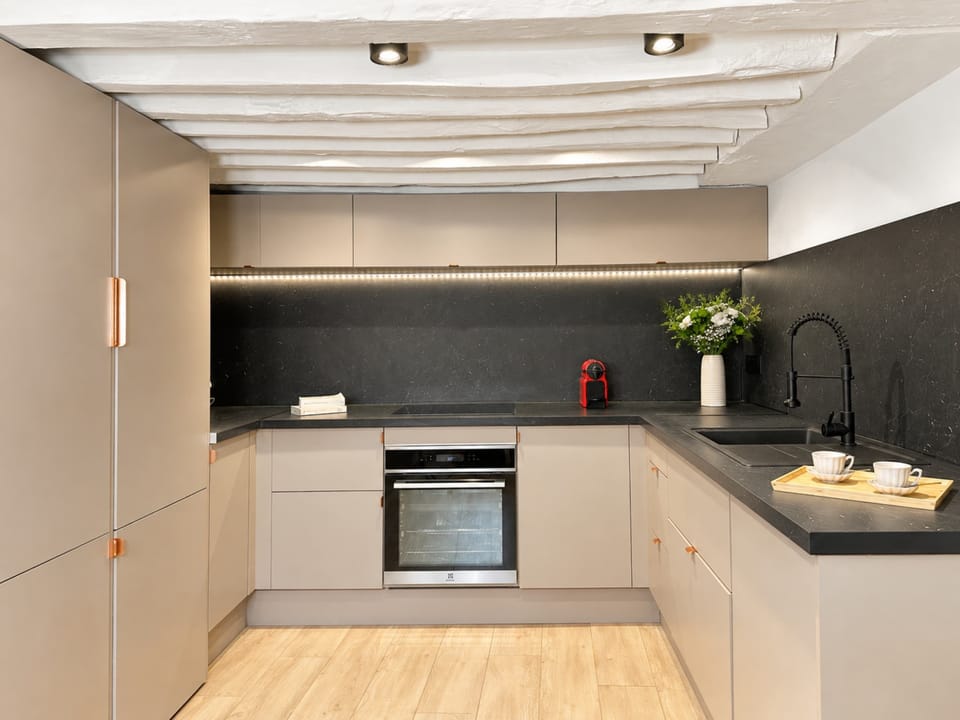 Sleek, contemporary kitchen with generous space and high-end appliances, perfect for culinary creations