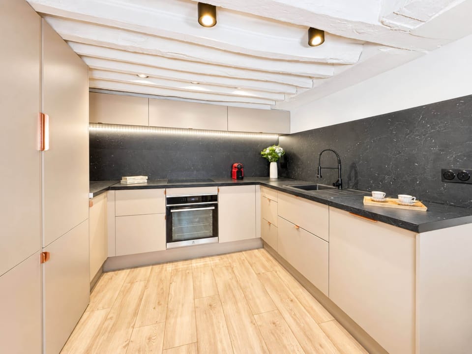 Spacious kitchen with a modern touch, offering a perfect space for both cooking and socializing