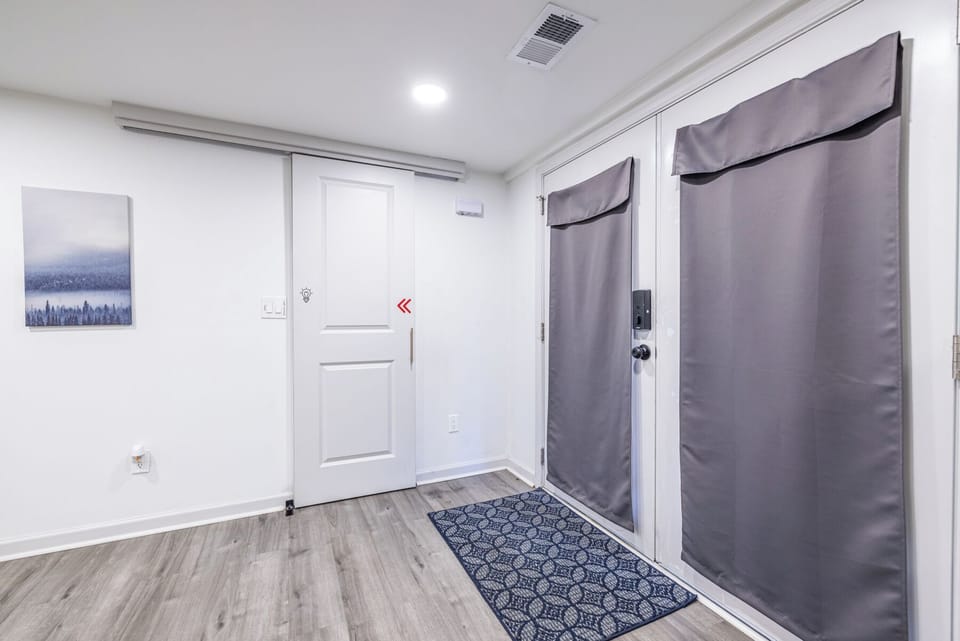 Welcomed by charming French doors, you’ll enter into a thoughtfully designed space with a stylish barn-door bathroom just steps away.