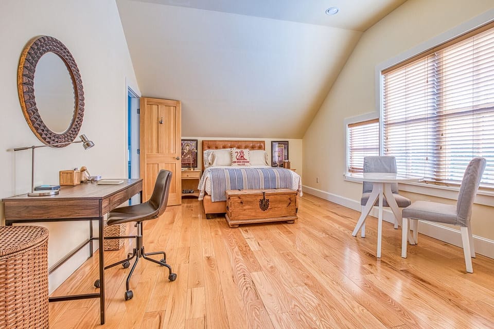 Primary bedroom with Queen bed and sitting area.