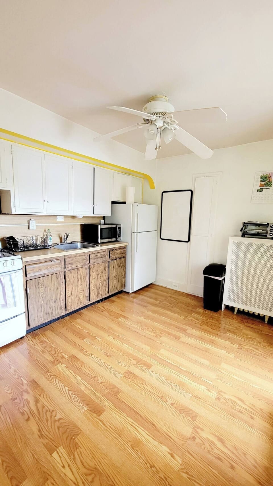 Step into a well-appointed kitchen designed for convenience. It includes a full-sized refrigerator, range, space for meal prep, and dining table. You'll find generous storage in the cabinetry, making it easy to keep things organized.
