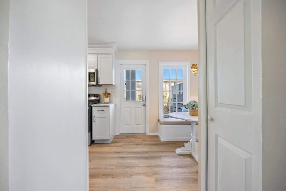 Bright kitchen nook with built-in bench seating and natural light from glass doors.