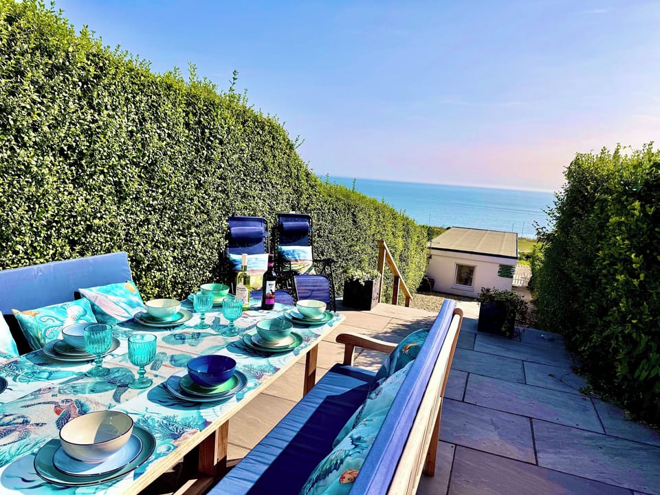 Enjoy alfresco dining for 8 on the patio, with dreamy sea views (Summer)