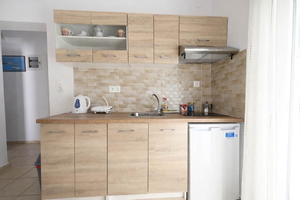 Kitchen Area – Fully Equipped with Cabinets, Sink, and Dining Space
