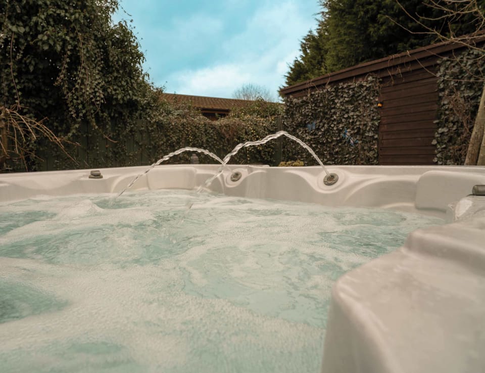Soak away your stress in the private outdoor hot tub. The ultimate luxury touch for your lodge stay—perfect for crisp evenings under the stars.