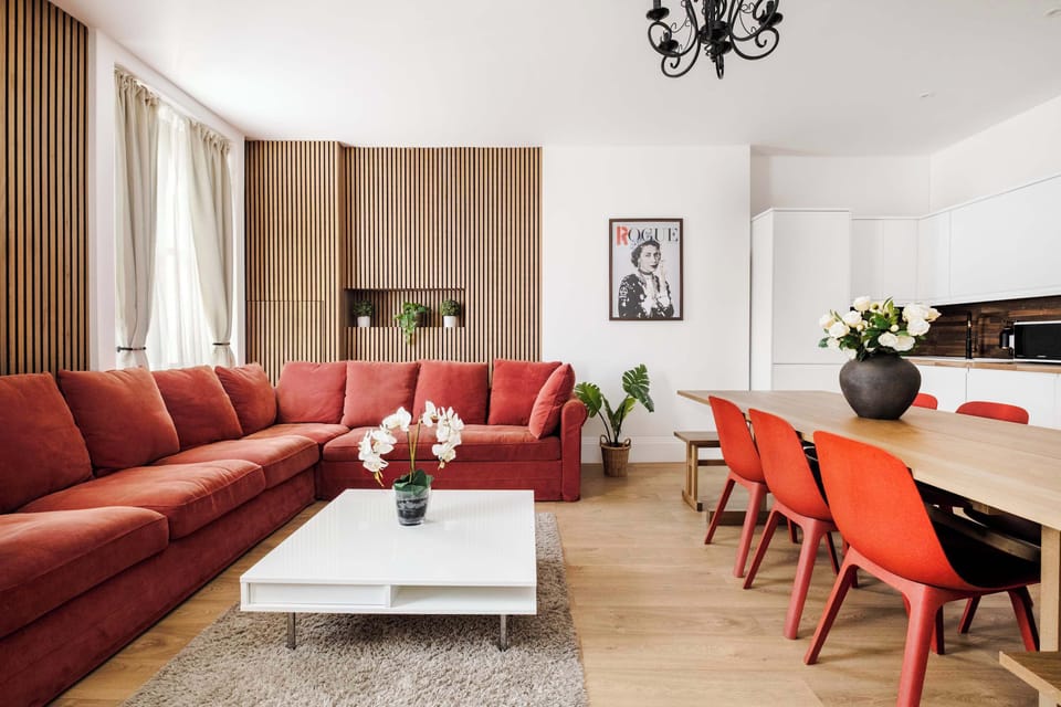 Living Room | The beautiful living room features a 75 inch TV, full air conditioning, and a large sofa that converts into a sofa bed, creating a bright space ideal for relaxing, unwinding after a day in the city, or enjoying quality time with family 
