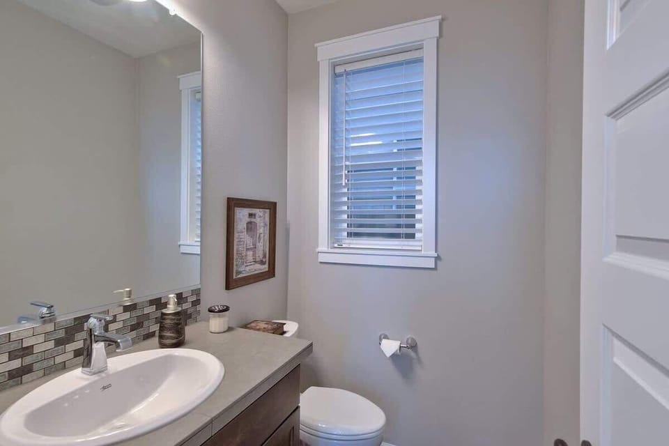 Convenient main-level powder room with modern finishes and thoughtful touches. 
