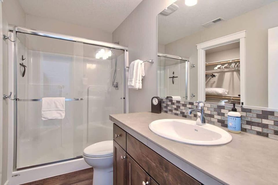 Refresh in a bright, modern bathroom featuring a walk-in shower and premium finishes. 