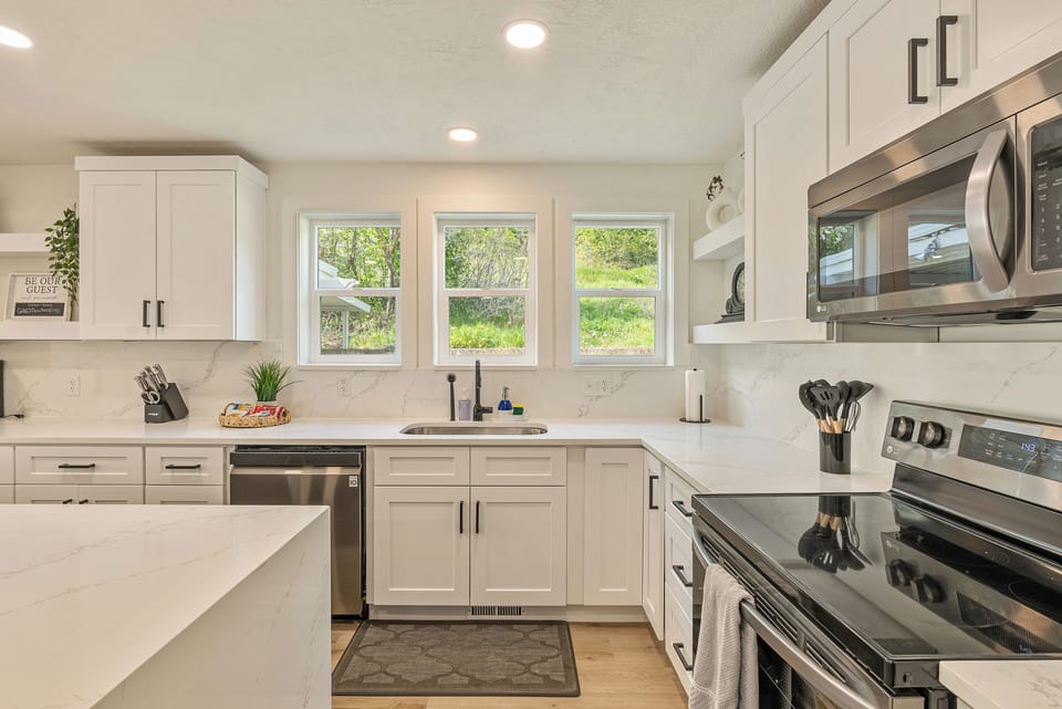 Beautiful kitchen with plenty of dishes, pots, and pans to cook grand meals. 