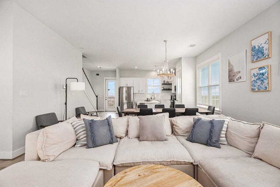 Stylish living room with plush sectional sofa, coastal accents, and open layout—ideal for family gatherings in this beach house.