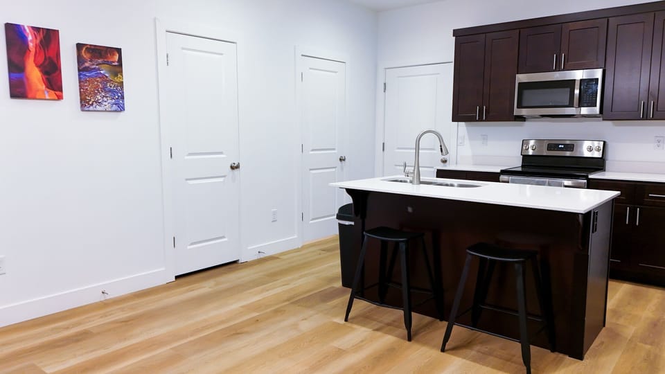 Fully stocked kitchen with modern appliances (coffee pot, toaster, blender)