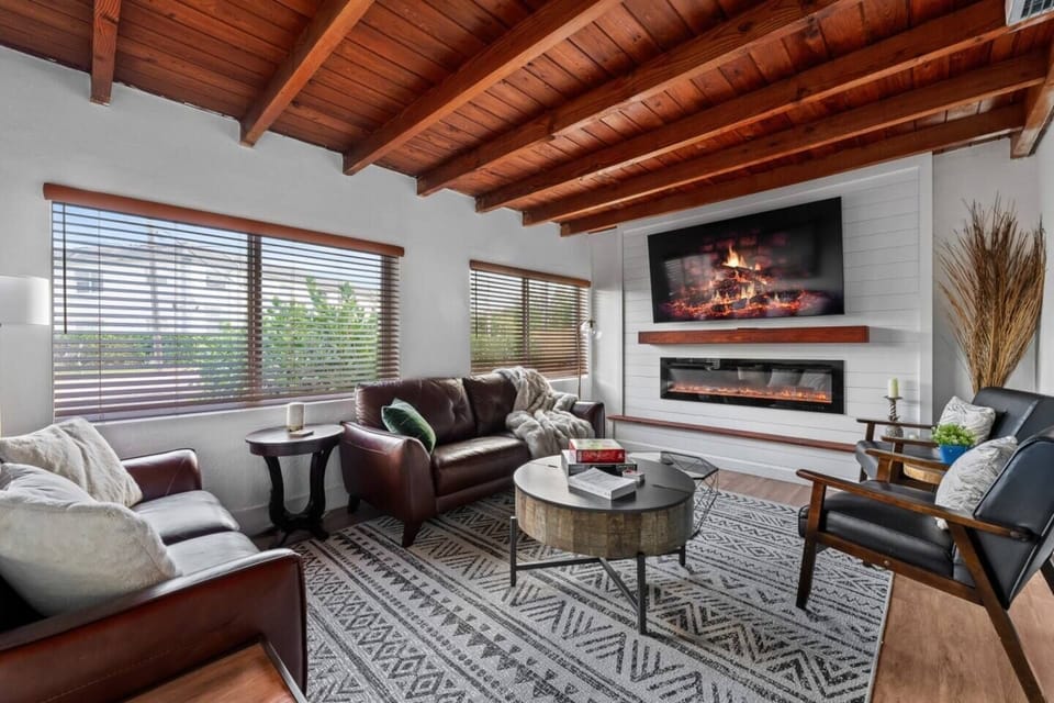 Unwind in this cozy living room, featuring plush seating and a warm ambiance—perfect for relaxing and spending quality time with loved ones.