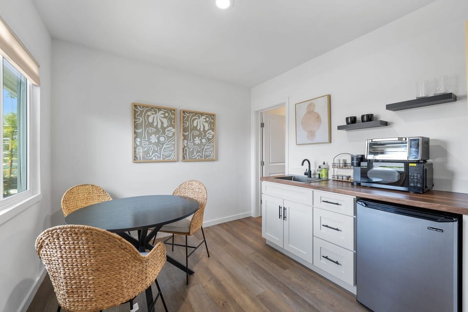 This modern, well equipped kitchenette with a small fridge, microwave, toaster oven/air fryer combo, and Keurig coffee maker -perfect for effortless meals and morning coffee.