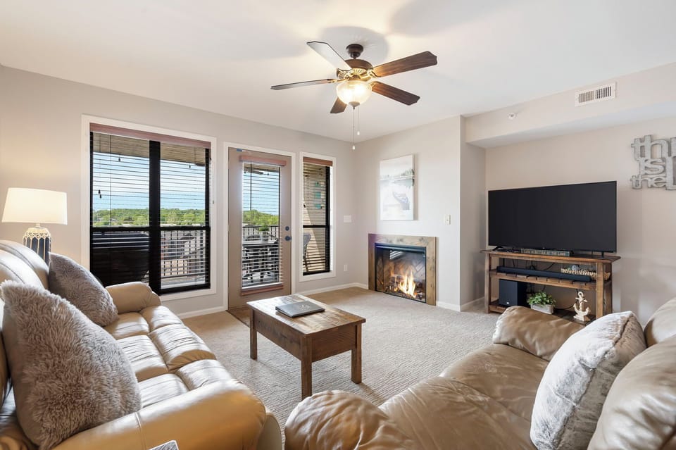 Living Room with Cable TV, Deck Access, and Seasonal Fireplace