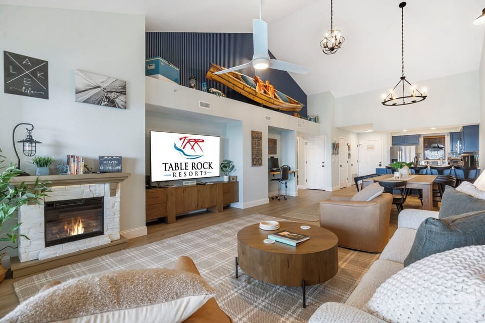 The Open Floor Plan Includes a Dedicated Work Space, a Comfortable Living Area,  a Full Kitchen with Additional Bar Seating, and Two Luxurious Bedrooms with Adjoining Baths