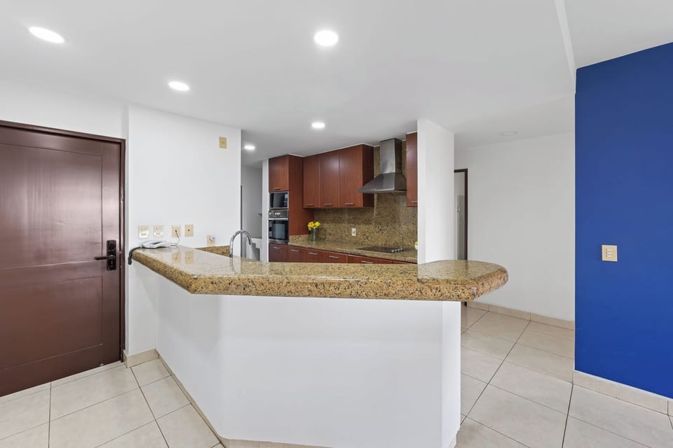 Modern kitchen with granite countertops.