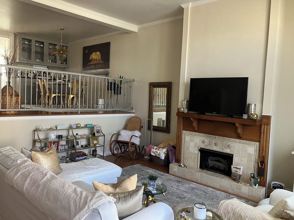 This beautiful, spacious and airy living room features cozy seating & smart tv.