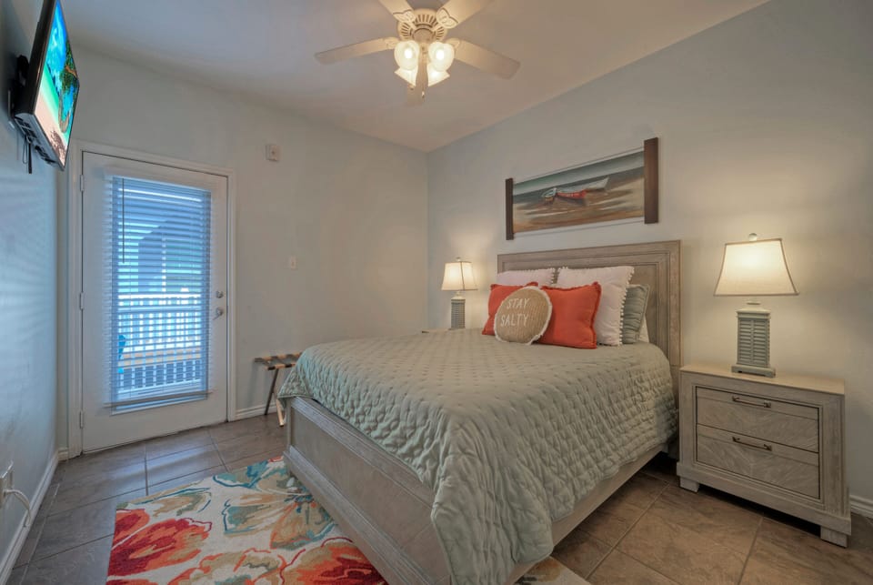 Bedroom 2 features a queen bed, TV, and an ensuite bathroom. (Costa Bahia 202)