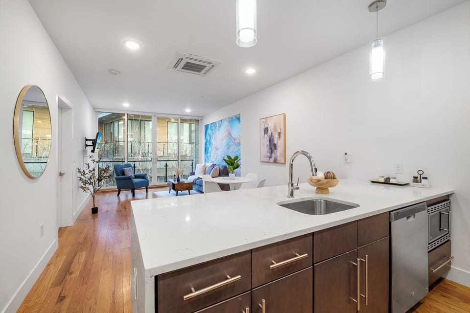  Kitchen and dining overview with island seating and open layout.