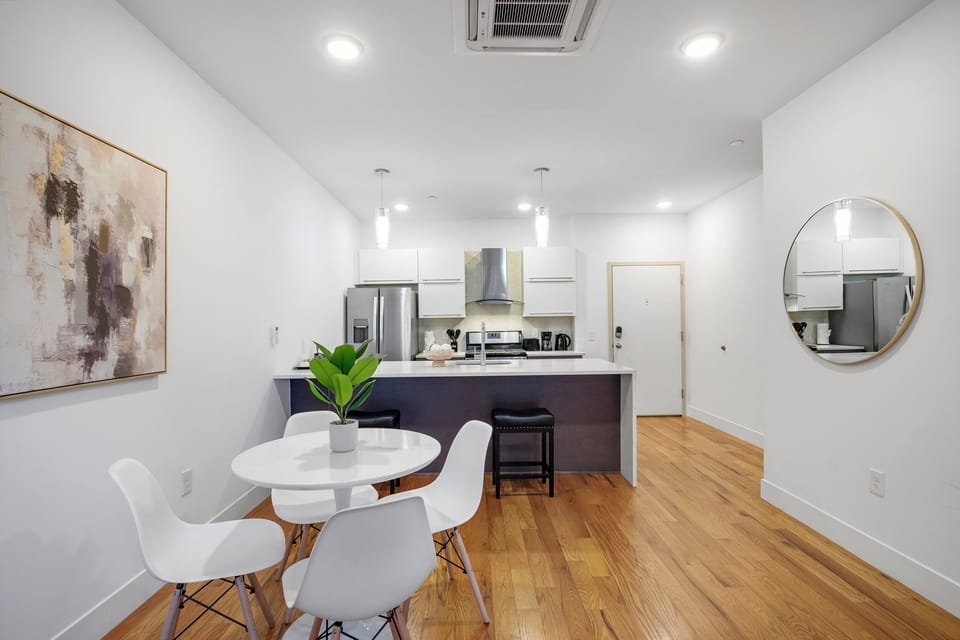 Open-concept living and dining area with hardwood floors maximizing space.