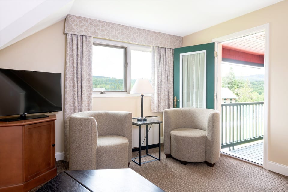 Bright and airy, this living area opens up to a balcony, offering a seamless blend of indoor comfort and outdoor enjoyment.