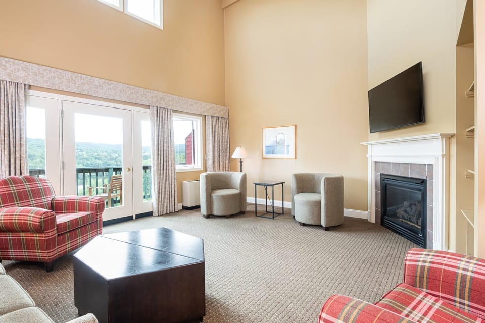 Comfortable living space with a fireplace and plenty of seating, ideal for cozy evenings with family or friends.