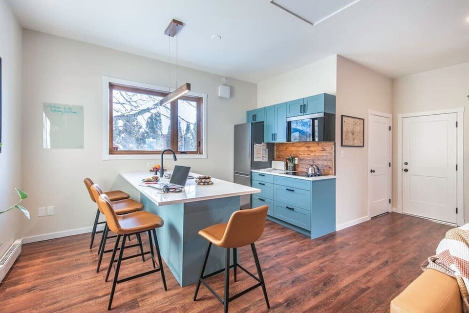 Fully-stocked kitchen with a large island that seats four.  Dishwasher, four burner electric cooktop, microwave convection oven (that has grilling and air-frying modes in addition to regular microwave mode), large refrigerator and freezer.