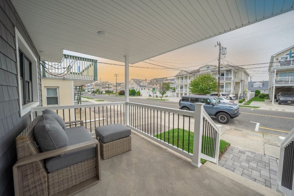 Relax and watch the neighborhood come to life from your private front porch, perfect for morning coffee or evening chats. Comfortable seating and a peaceful street view create the ideal outdoor retreat.