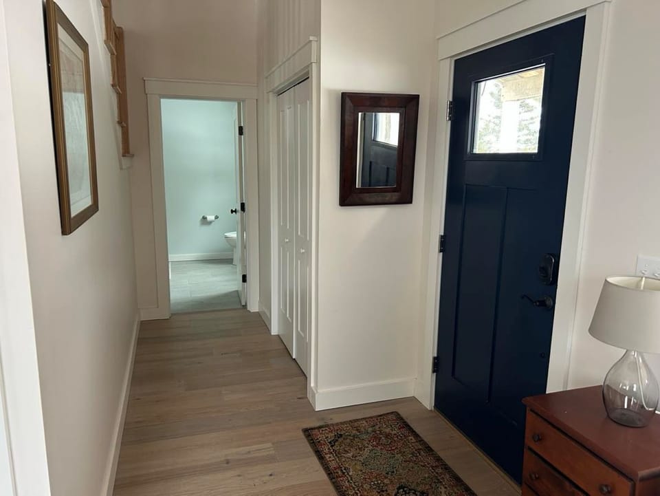 front door with view of the half bath