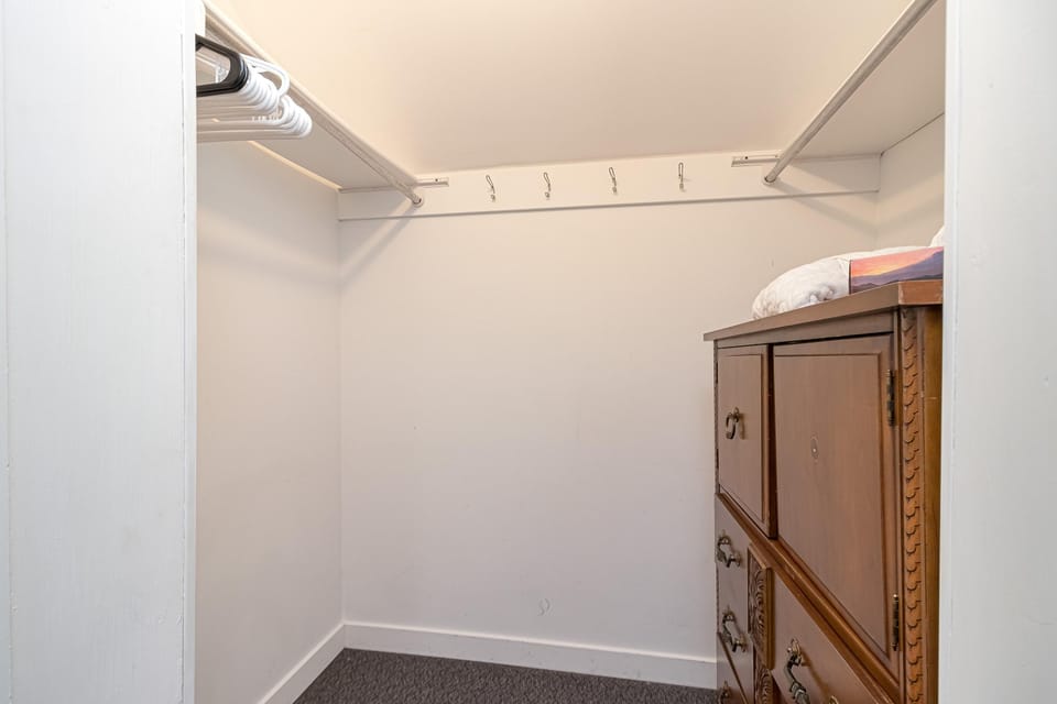 Spacious walk-in closet with ample storage and shelving