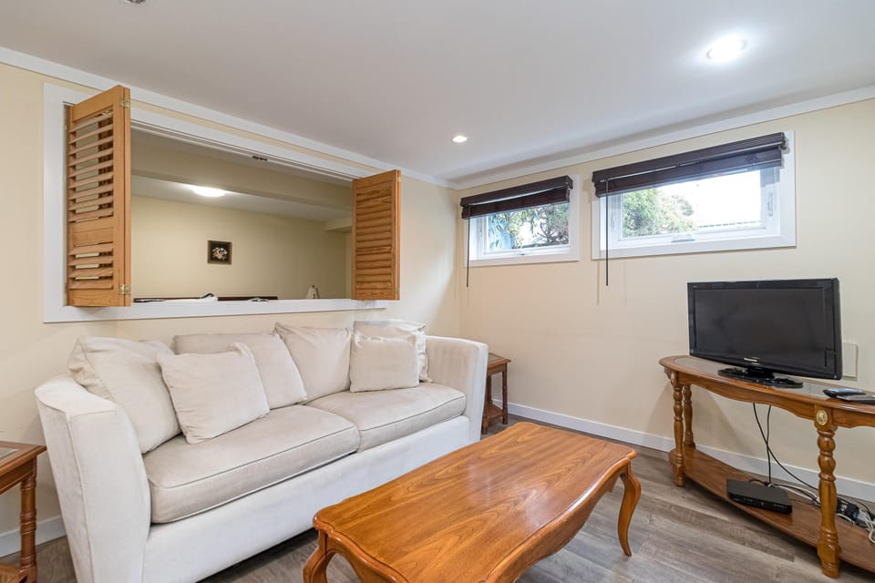 Cozy living room with comfortable sofa, smart TV and natural light