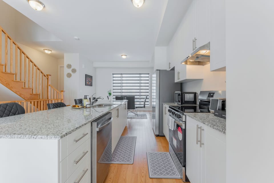 A modern kitchen with stainless steel appliances and sleek granite countertops.