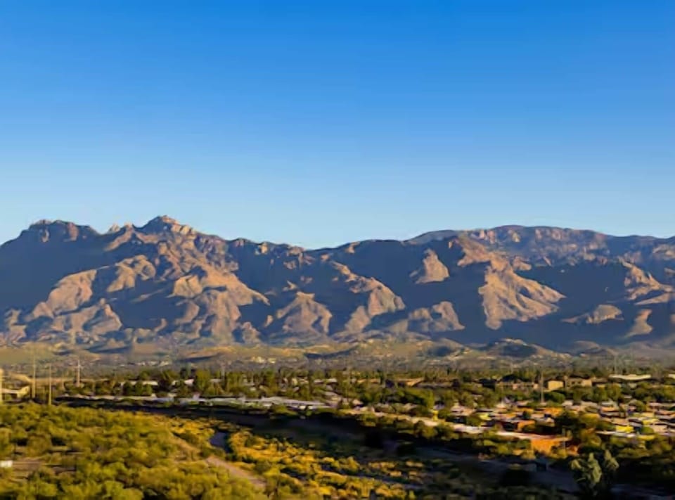 Watch golden light roll across the mountains beyond the city.
