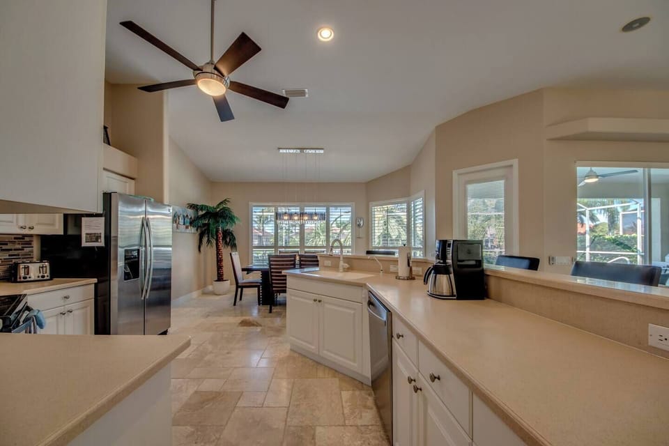Large kitchen with stainless steel appliances and bar stools for 4 people (2)
