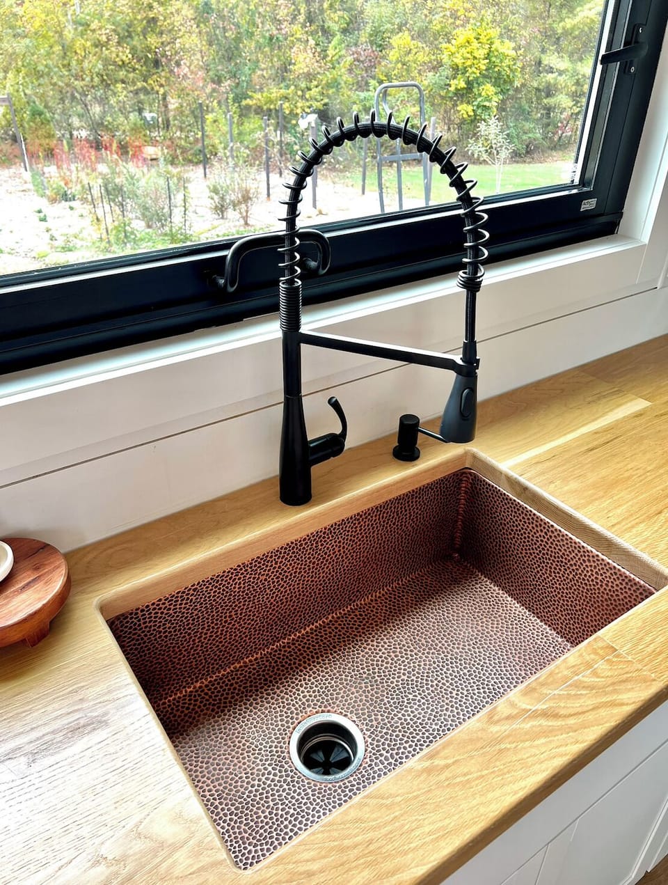 copper pebble textured sink with garage disposal. 