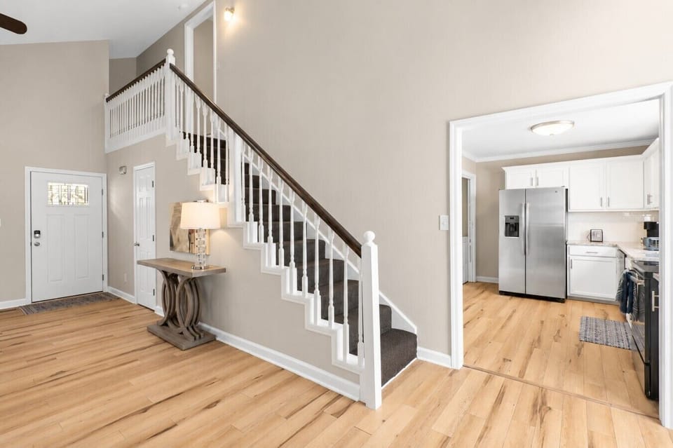 Welcome home! The bright and open entryway features soaring vaulted ceilings, beautiful hardwood floors, and a spacious layout that creates an inviting first impression from the moment you walk through the door.