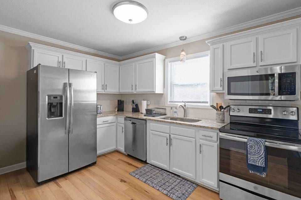 Bright, fully equipped kitchen with stainless steel appliances and ample cabinet space