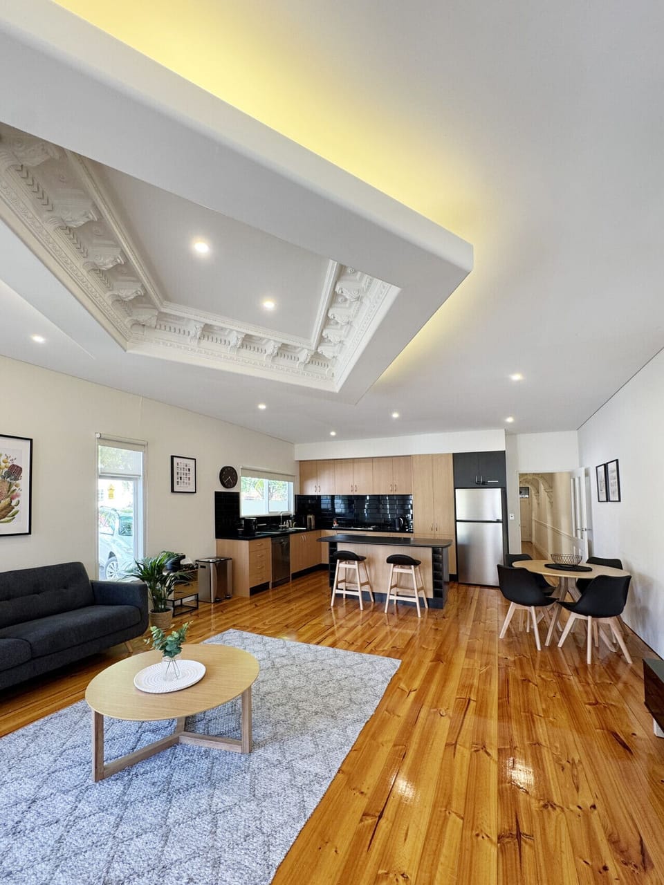 Relax in this stylish lounge space framed by large windows, contemporary décor, and a beautifully restored feature ceiling.