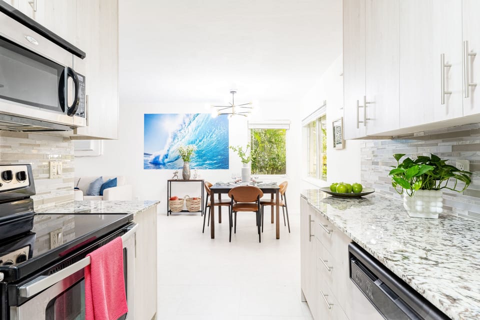 The adjacent full kitchen is equipped with high-end appliances